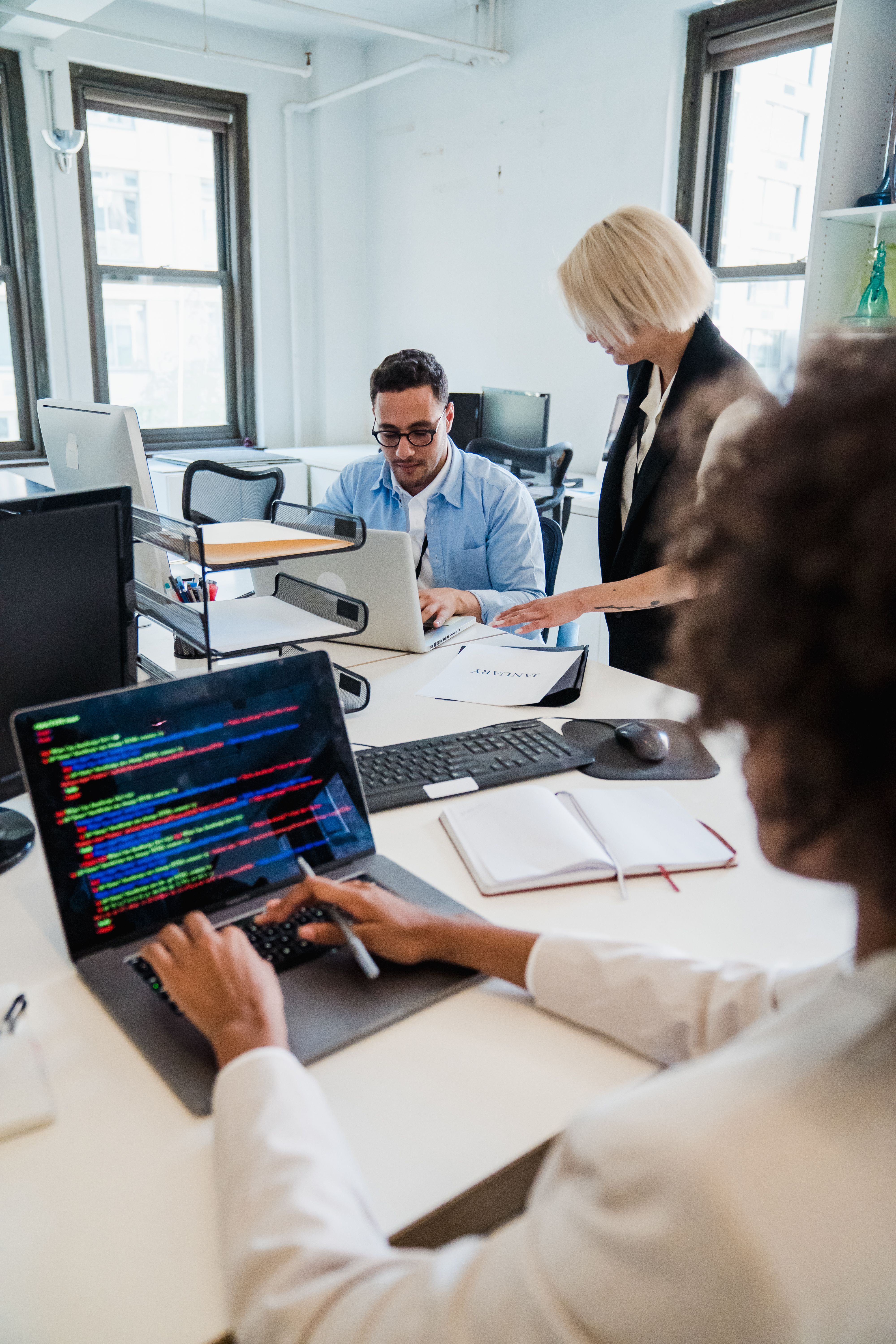 A software consulting conversation around a laptop