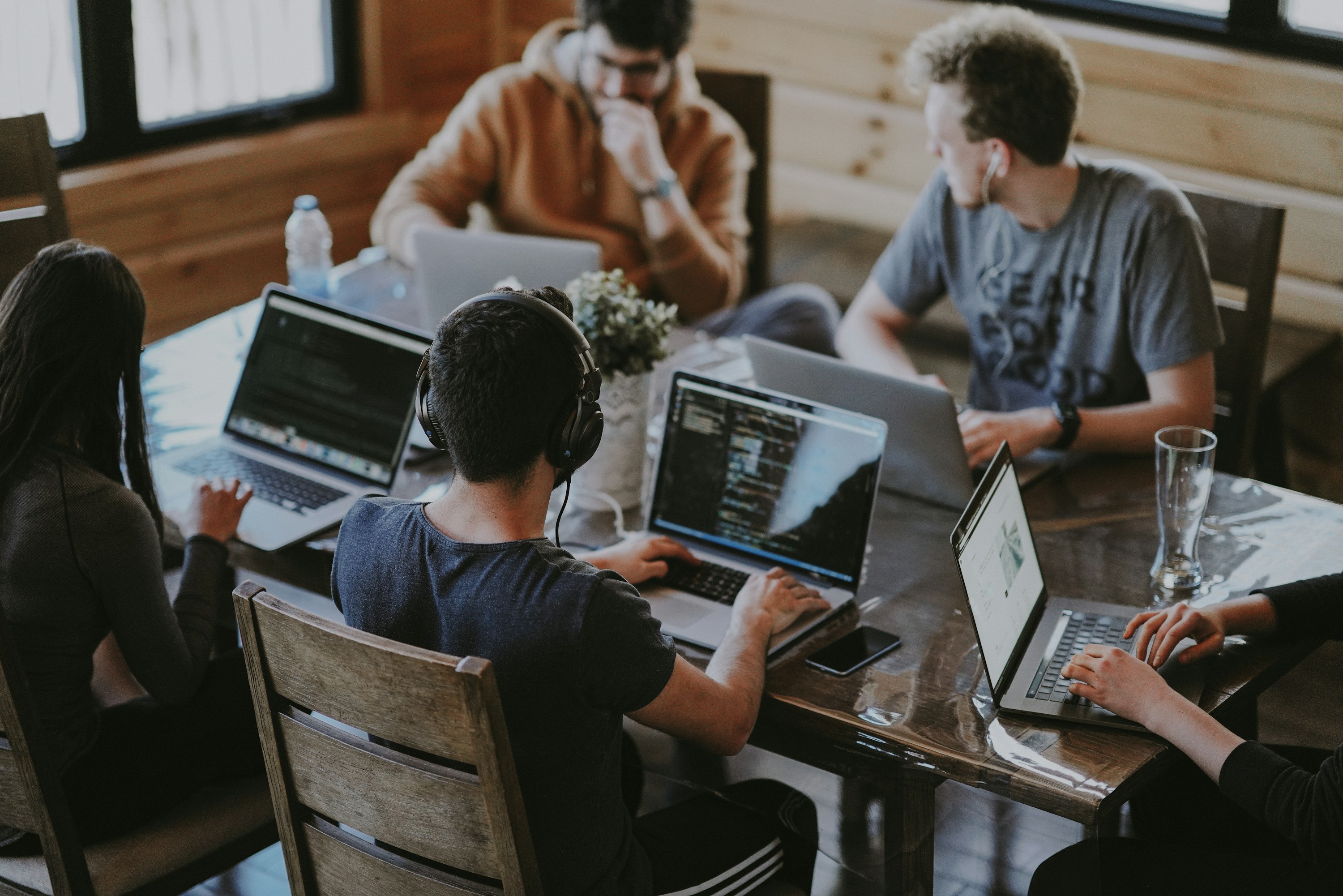 A software team collaborating around laptops